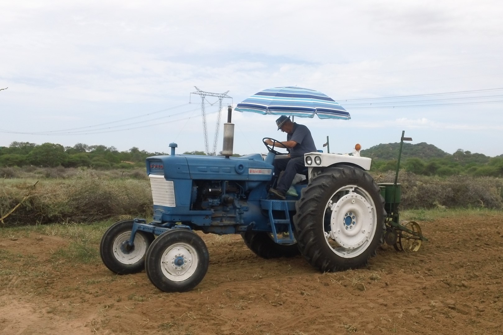 Faithful partner, Bob Luckhurst on the tractor he donated along with friends in the States